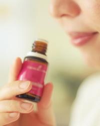woman smelling essential oil bottle